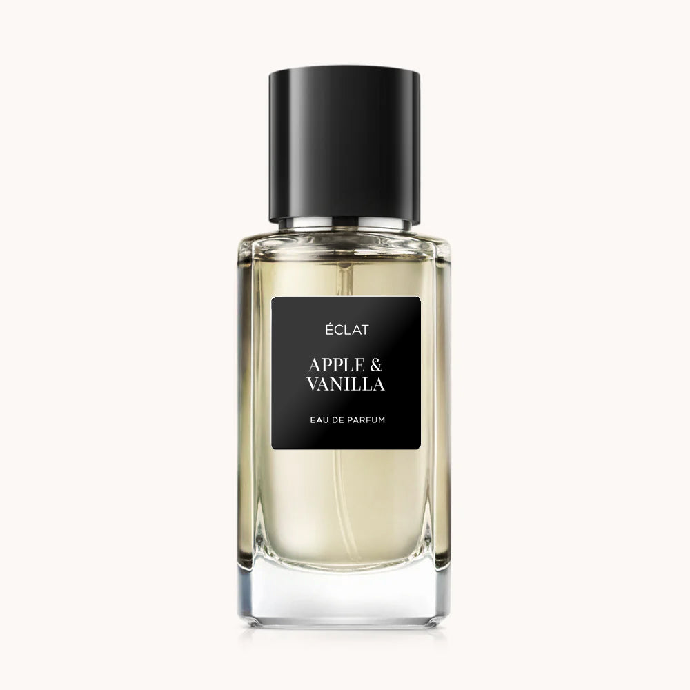 ÉCLAT Apple & Vanilla Duft in einem klaren facettierten Glasflakon mit schwarzer Kappe und elegantem schwarzen Etikett.