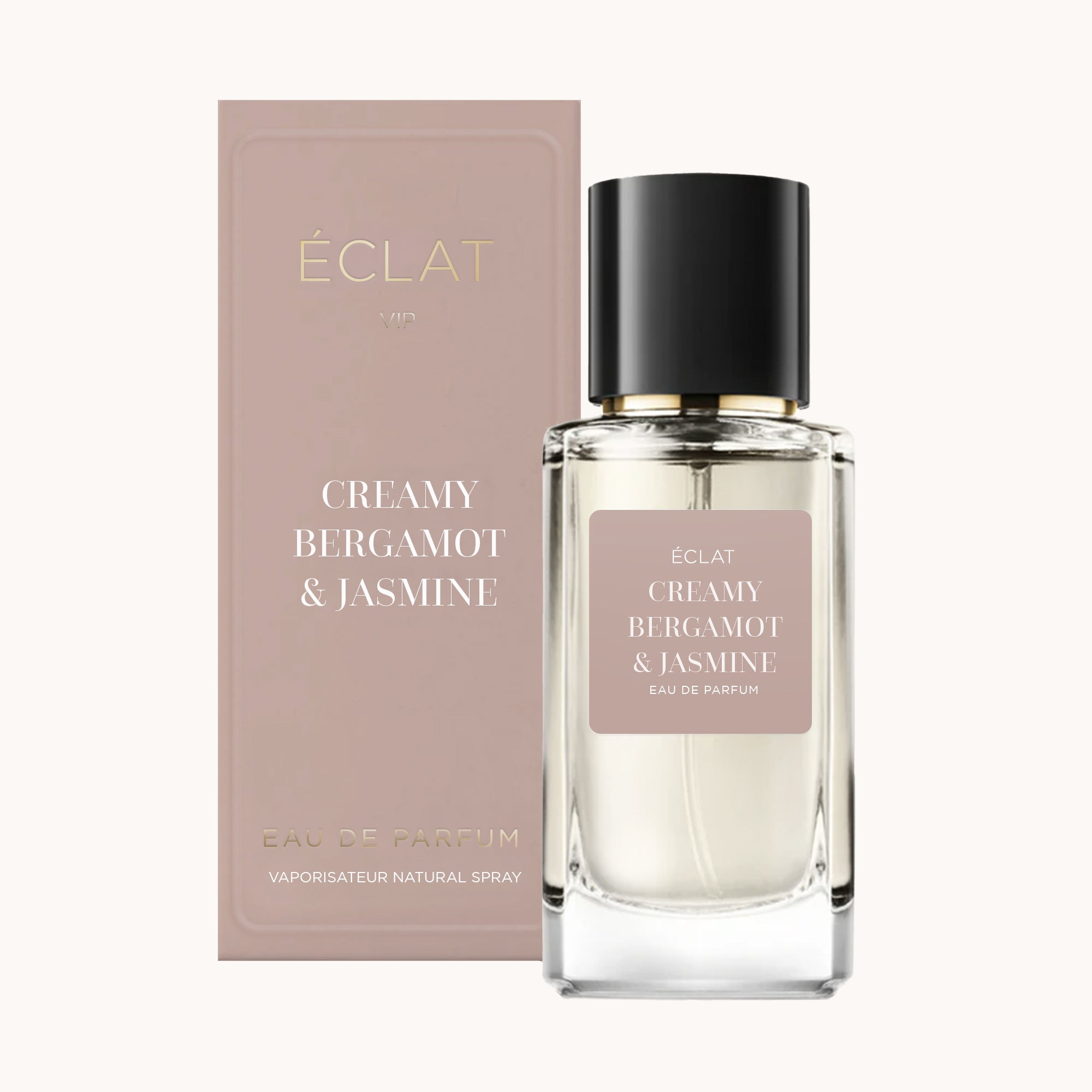 ÉCLAT Creamy Bergamot & Jasmine Parfümflakon mit transparentem, facettiertem Design und schwarzer Kappe, neben passender rosafarbener Box.