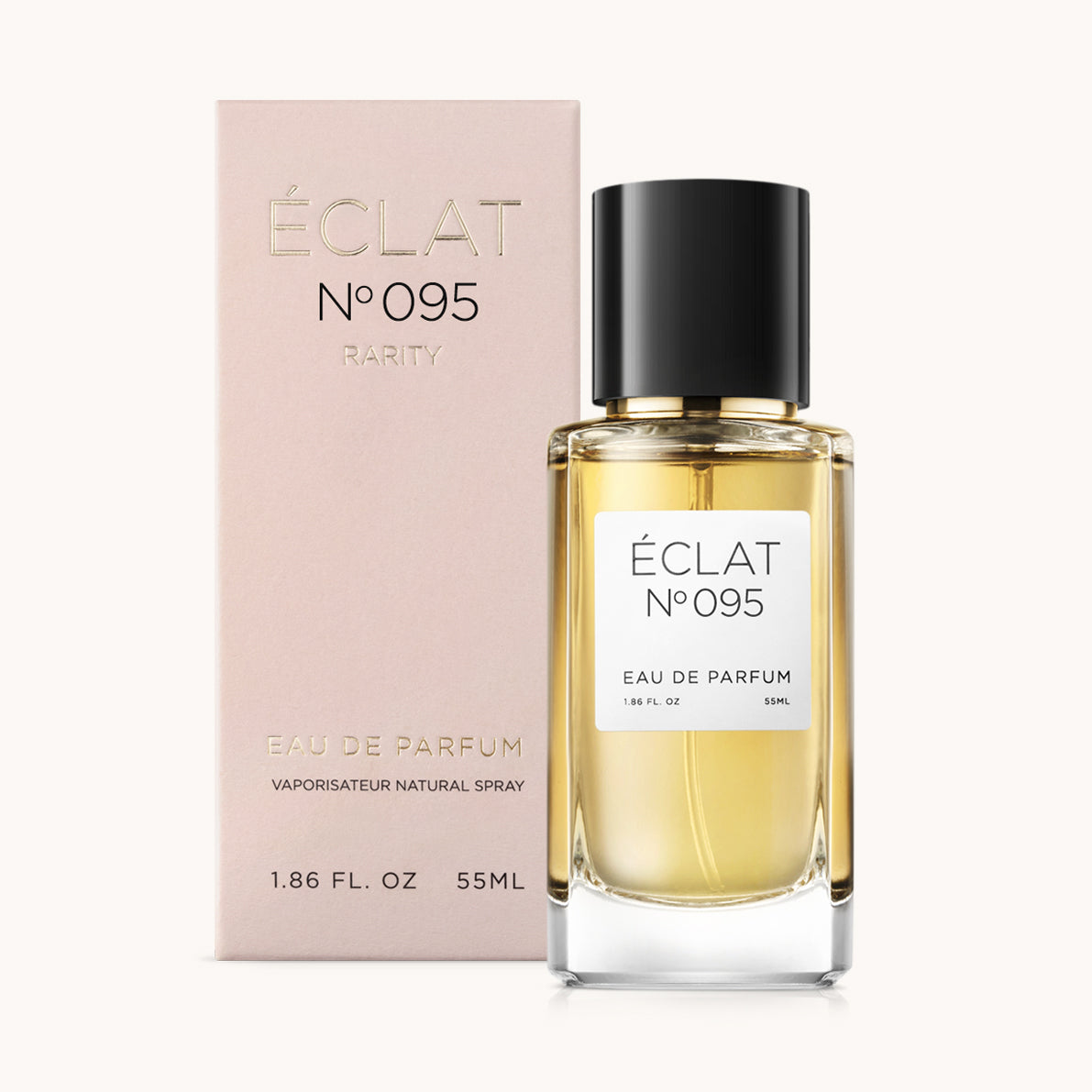 Das ÉCLAT Floral Almond Parfum präsentiert sich in einem klaren Glasflakon mit schwarzem Verschluss neben einer rosafarbenen Schachtel mit goldfarbener Beschriftung.