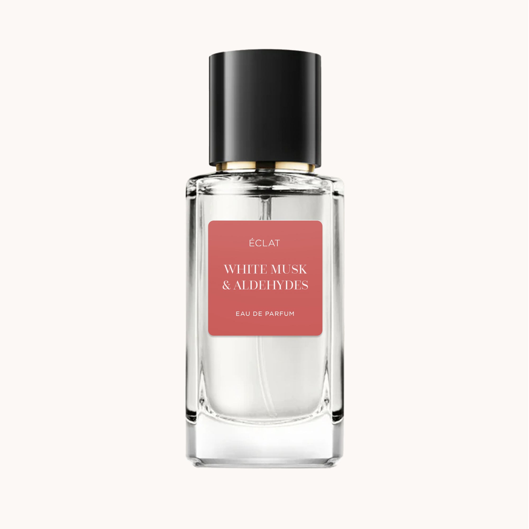 ÉCLAT White Musk & Aldehydes in einem facettierten Glasflakon mit schwarzem Verschluss und mattem rosa Etikett.