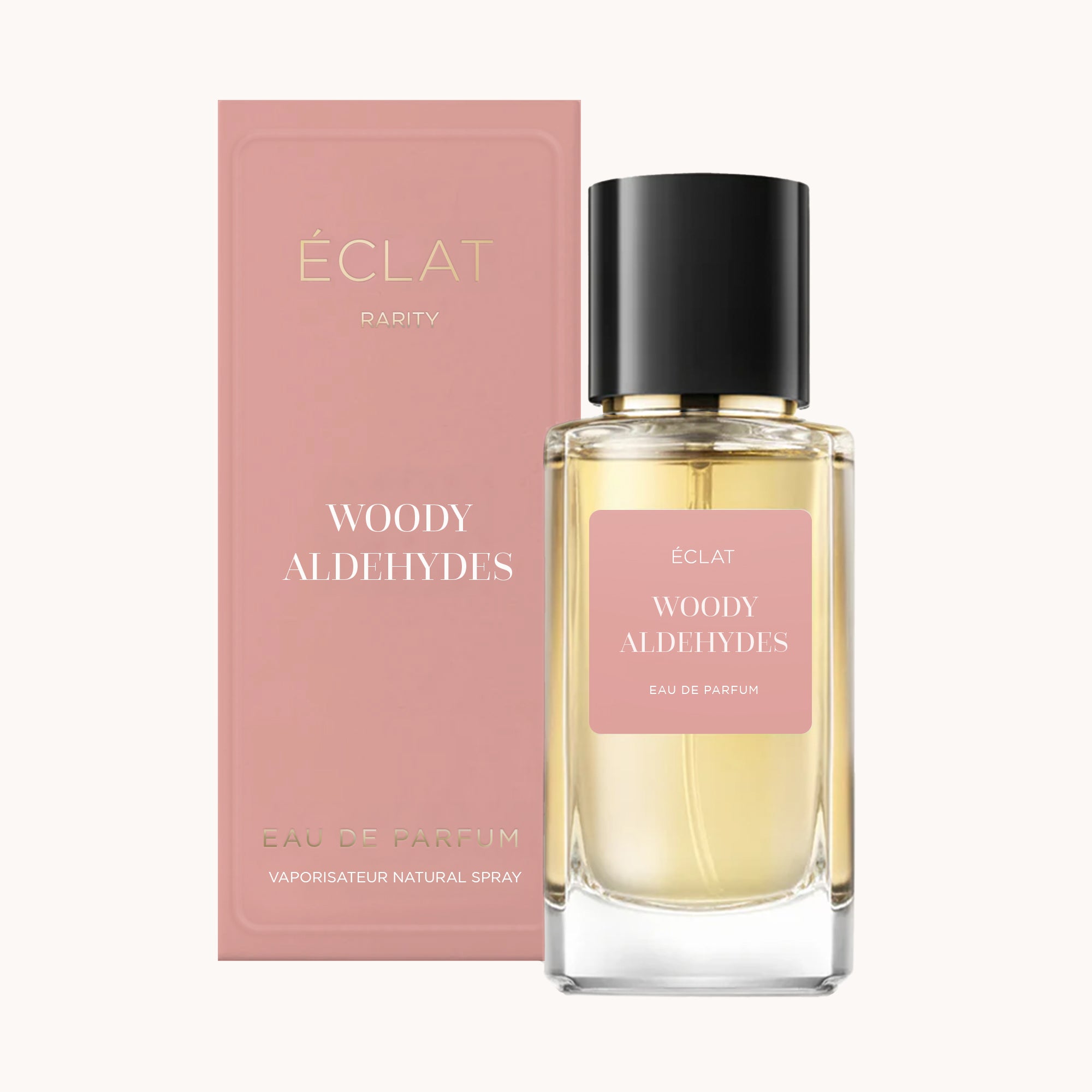 ÉCLAT Woody Aldehydes im facettierten Glasflakon mit schwarzem Verschluss, begleitet von einer rosafarbenen Box.