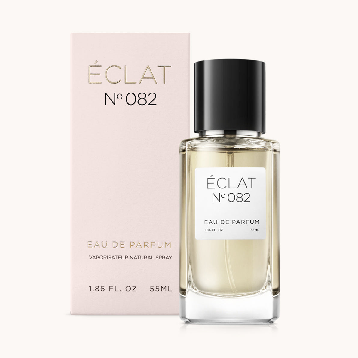 ÉCLAT Woody Lemon Parfümflakon mit schwarzem Verschluss neben einer rosa Box mit goldfarbener Schrift.
