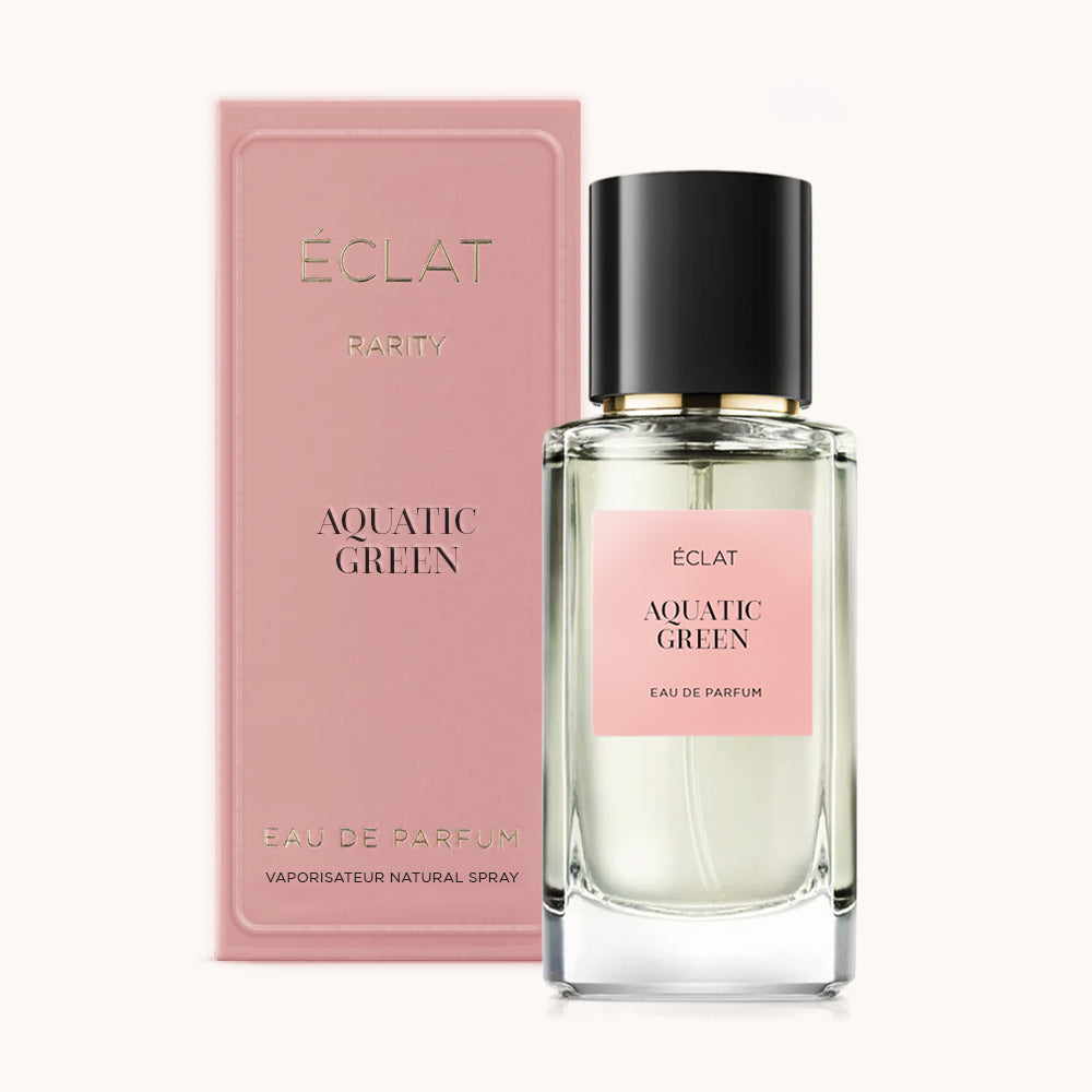 ÉCLAT Aquatic Green RAR in einem klaren Glasflakon mit schwarzem Verschluss, begleitet von einer rosa Box mit eleganter Markenaufmachung.