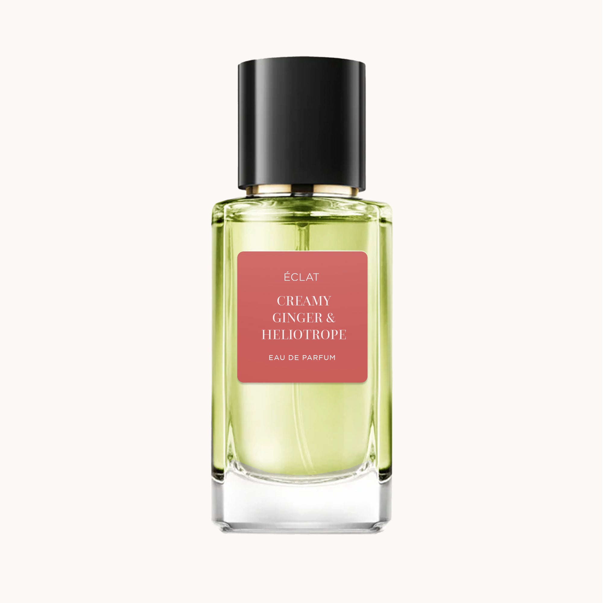 Ein facettierter Glasflakon von ÉCLAT Creamy Ginger & Heliotrope mit schwarzem Verschluss und rosa Etikett.