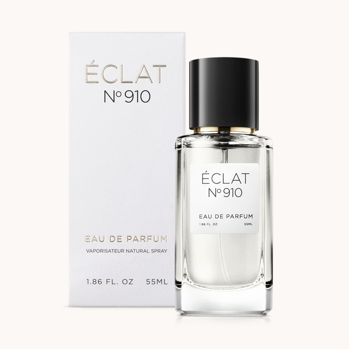 Ein facettierter Glasflakon von ÉCLAT Creamy White mit schwarzem Verschluss steht neben seiner eleganten weißen Verpackung.