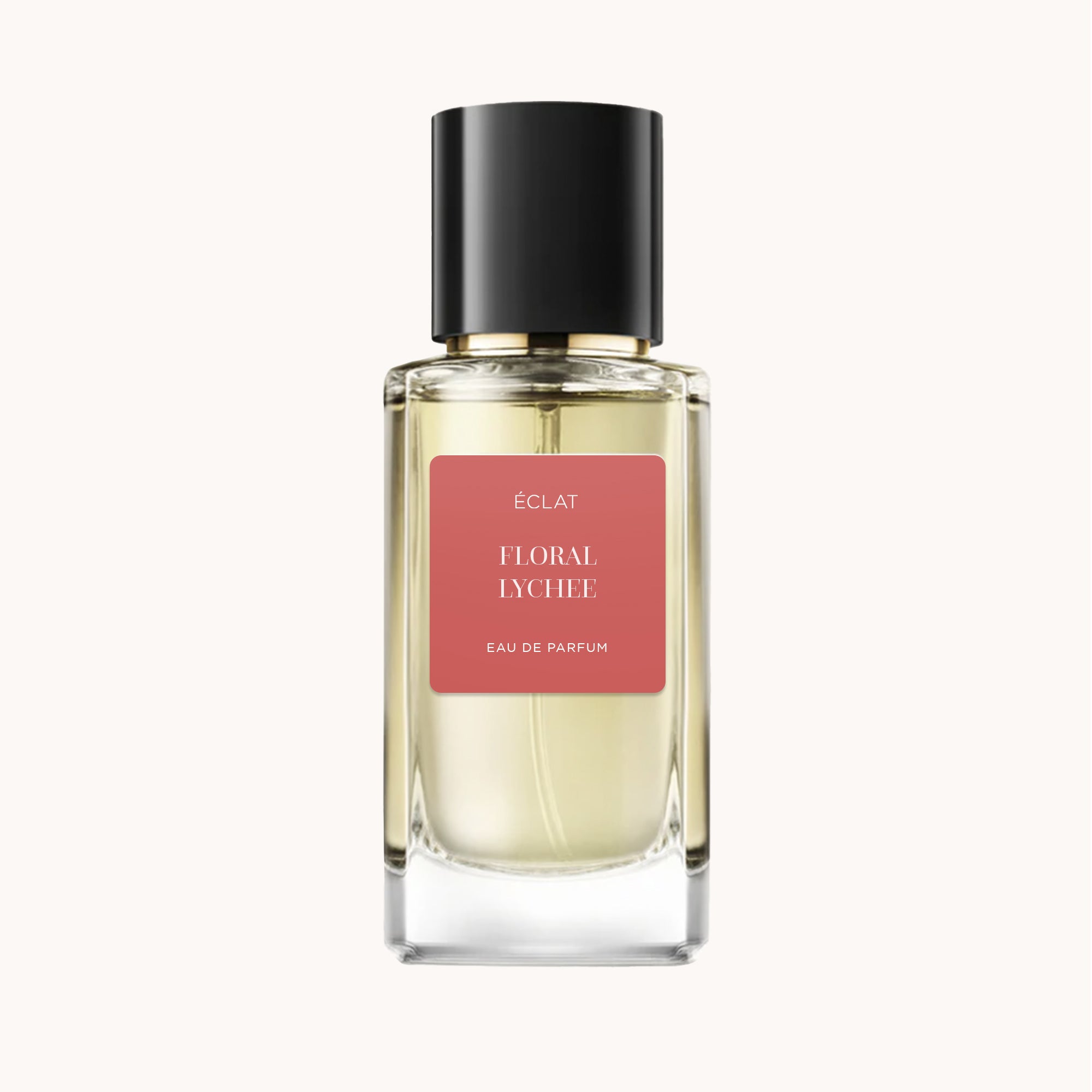 Facettierter Glasflakon mit schwarzem Verschluss, mattes Etikett in warmem Rosa mit dem Namen ÉCLAT Floral Lychee.