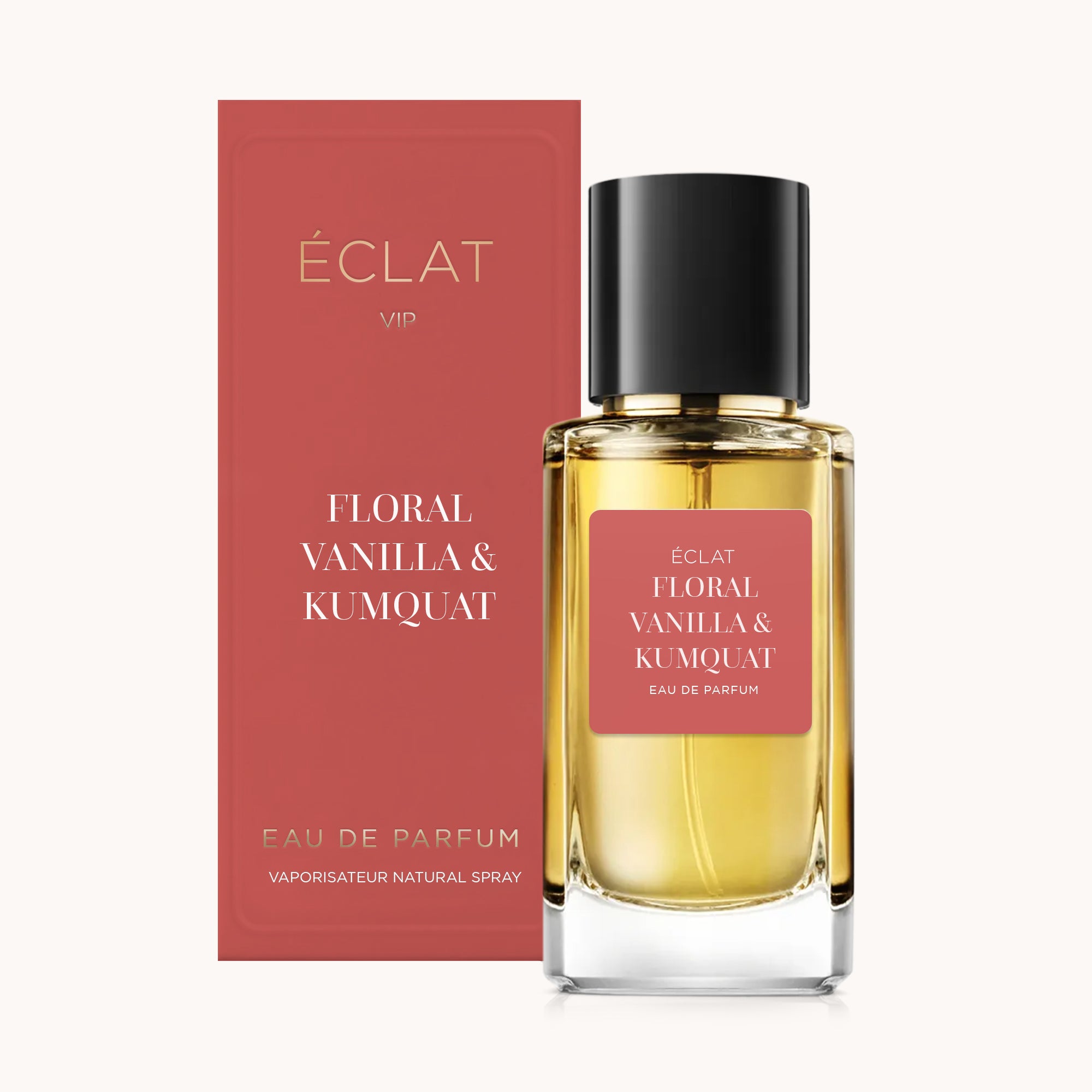 ÉCLAT Floral Vanilla & Kumquat Parfümflakon mit rosa Etikett und passender Box, mit schwarzem Verschluss.