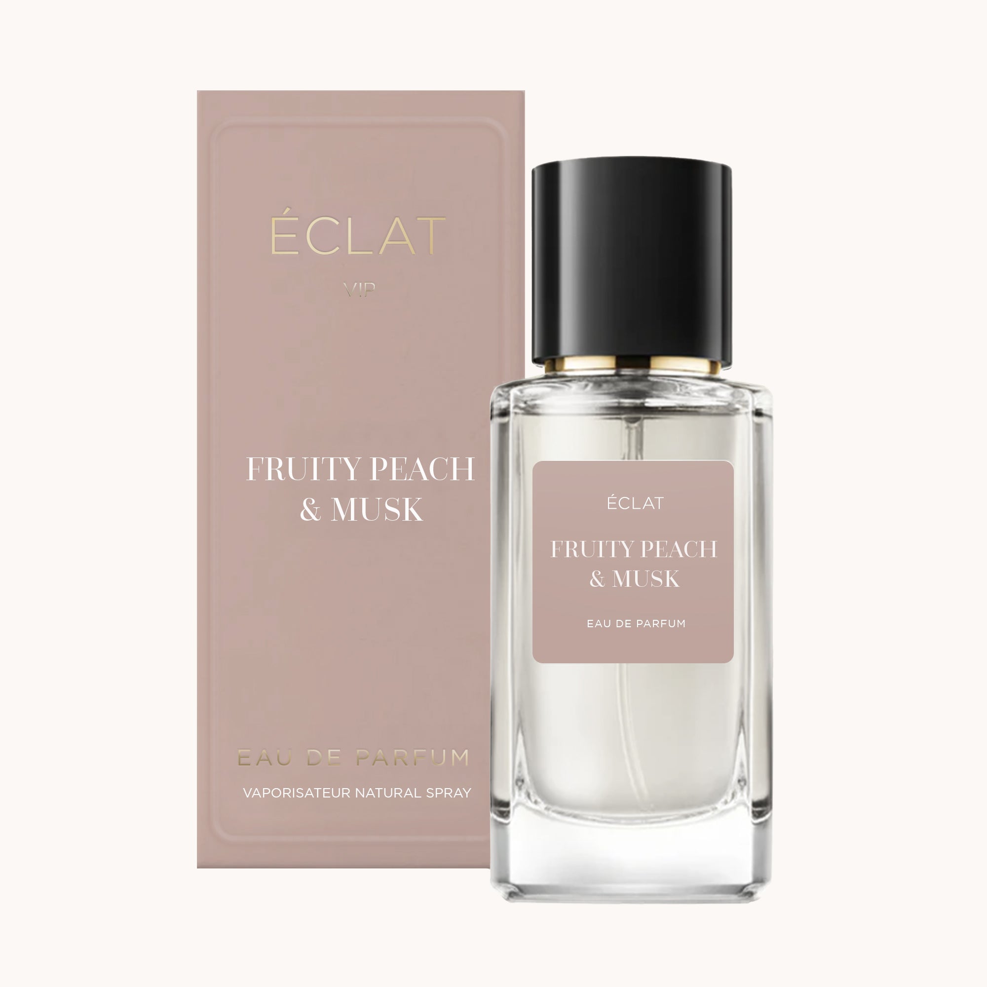 Ein klarer Glasflakon von ÉCLAT Fruity Peach & Musk mit schwarzem Verschluss neben einer zartrosa Schachtel.