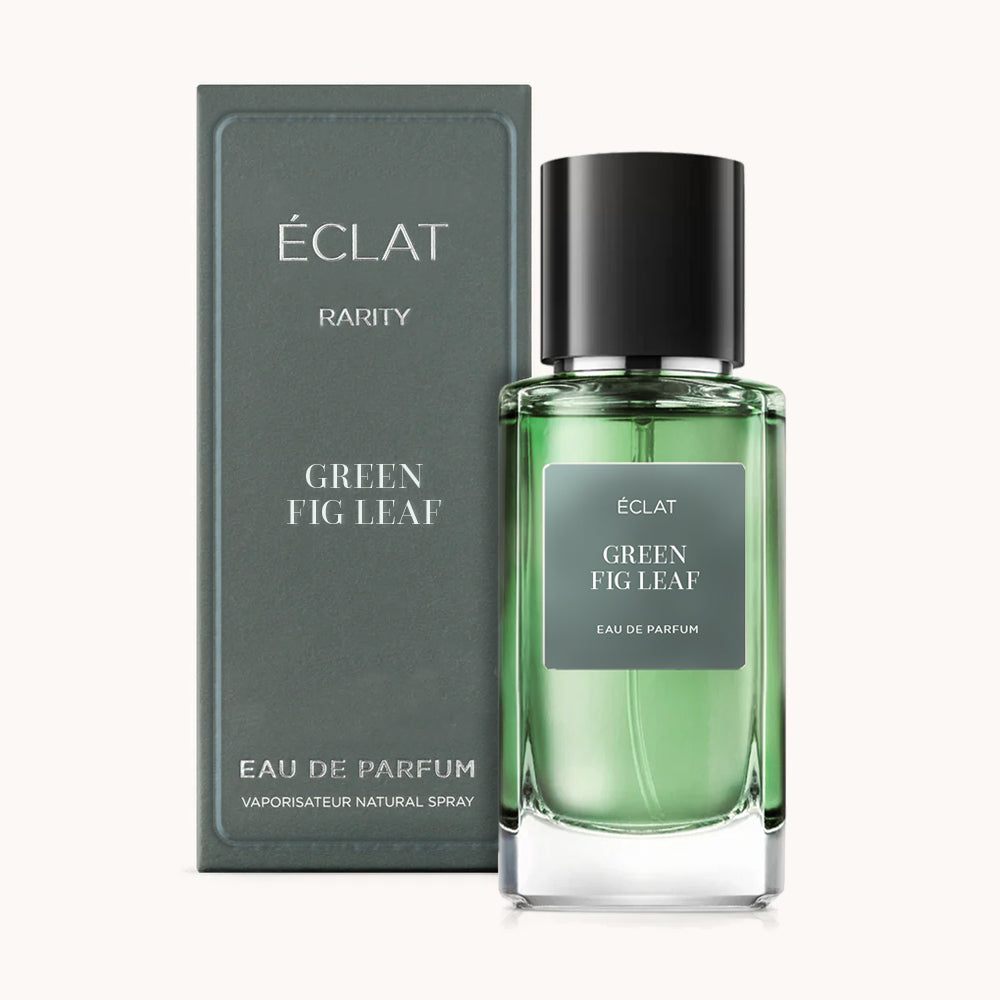 ÉCLAT Green Fig Leaf in einem transparenten grünen Glasflakon mit schwarzem Verschluss, daneben eine passende grüne Box mit silberner Schrift.
