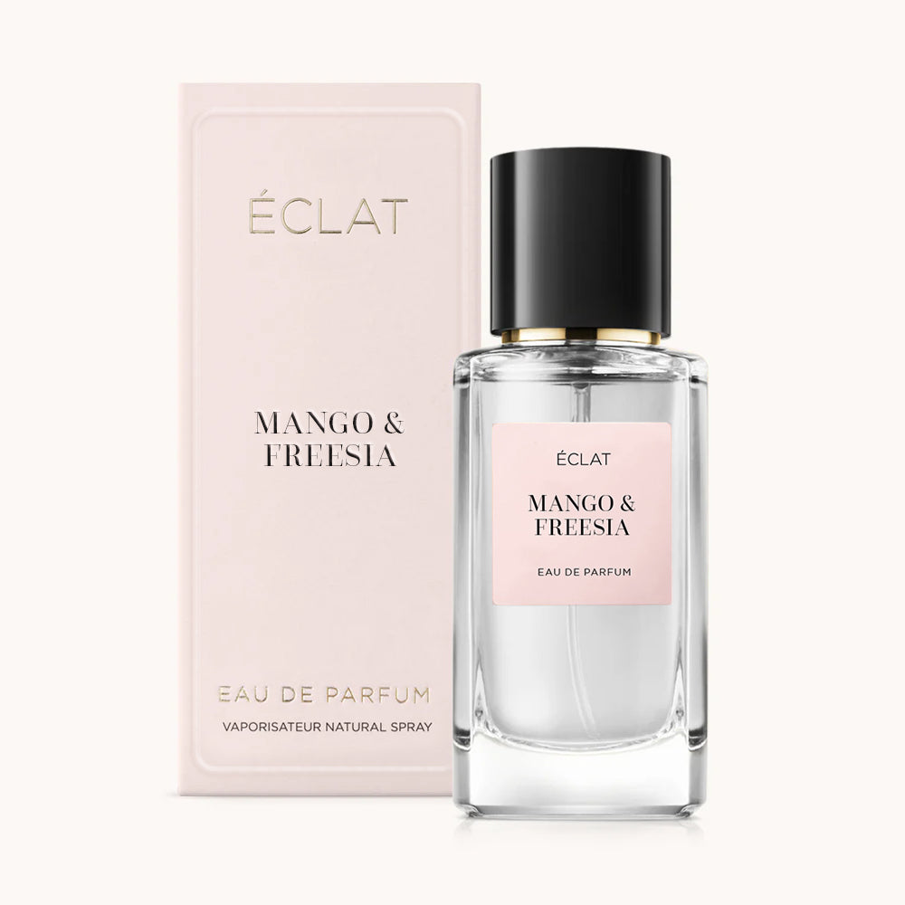 ÉCLAT Mango & Freesia Parfum in einem klaren Glasflakon mit schwarzem Verschluss, begleitet von einer roséfarbenen Verpackungsbox.