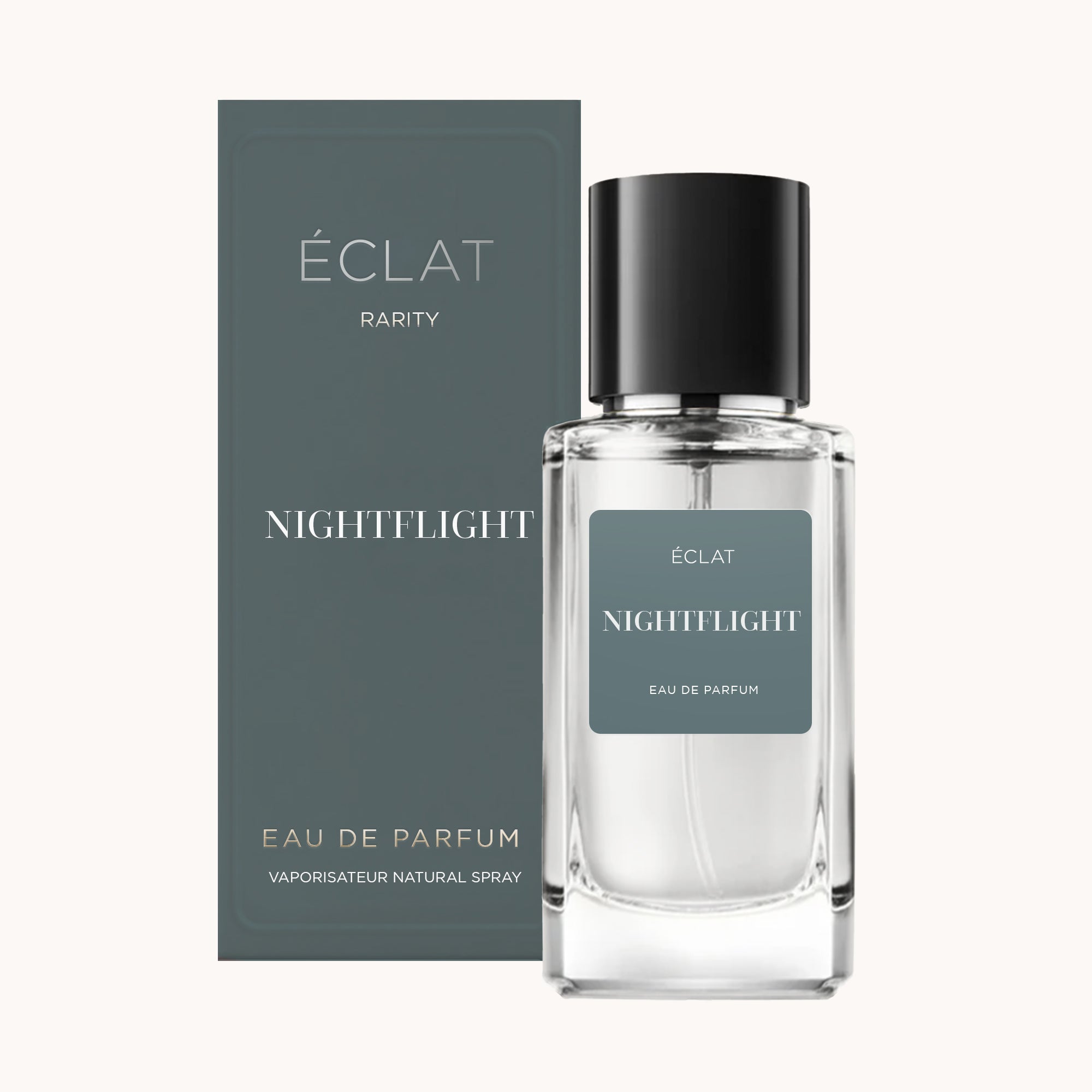 Der Duft ÉCLAT Nightflight präsentiert sich in einem klaren Glasflakon mit einer eleganten schwarzen Kappe und einer dunklen grauen Box.