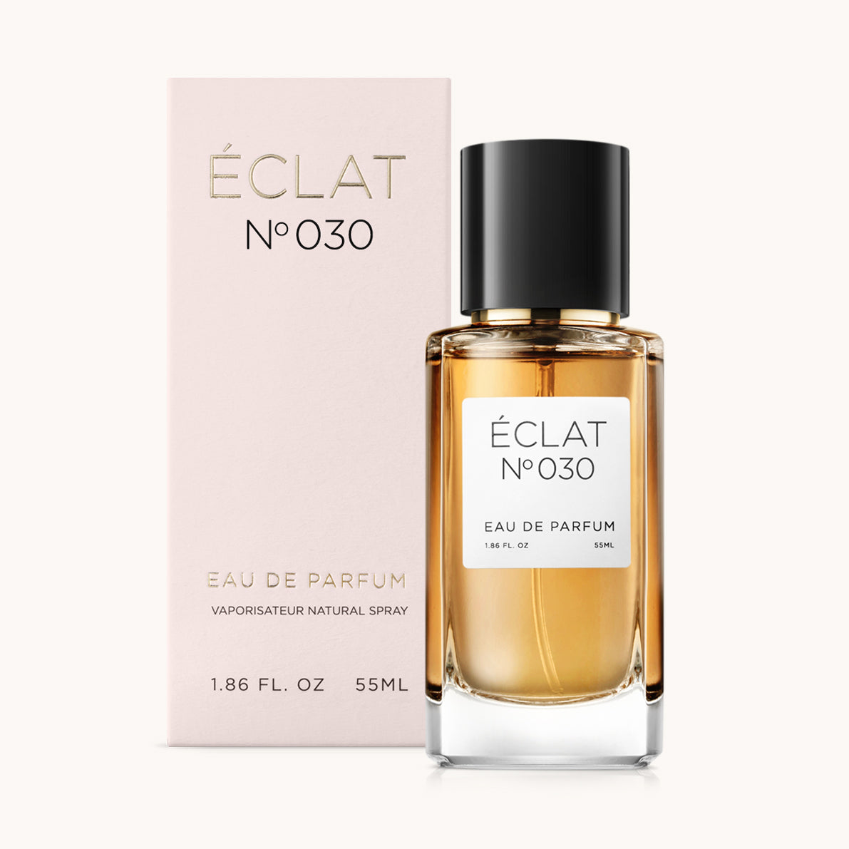 Facettierter Glasflakon von ÉCLAT Powdery Daffodil mit schwarzer Kappe neben einer zarten rosa Box.
