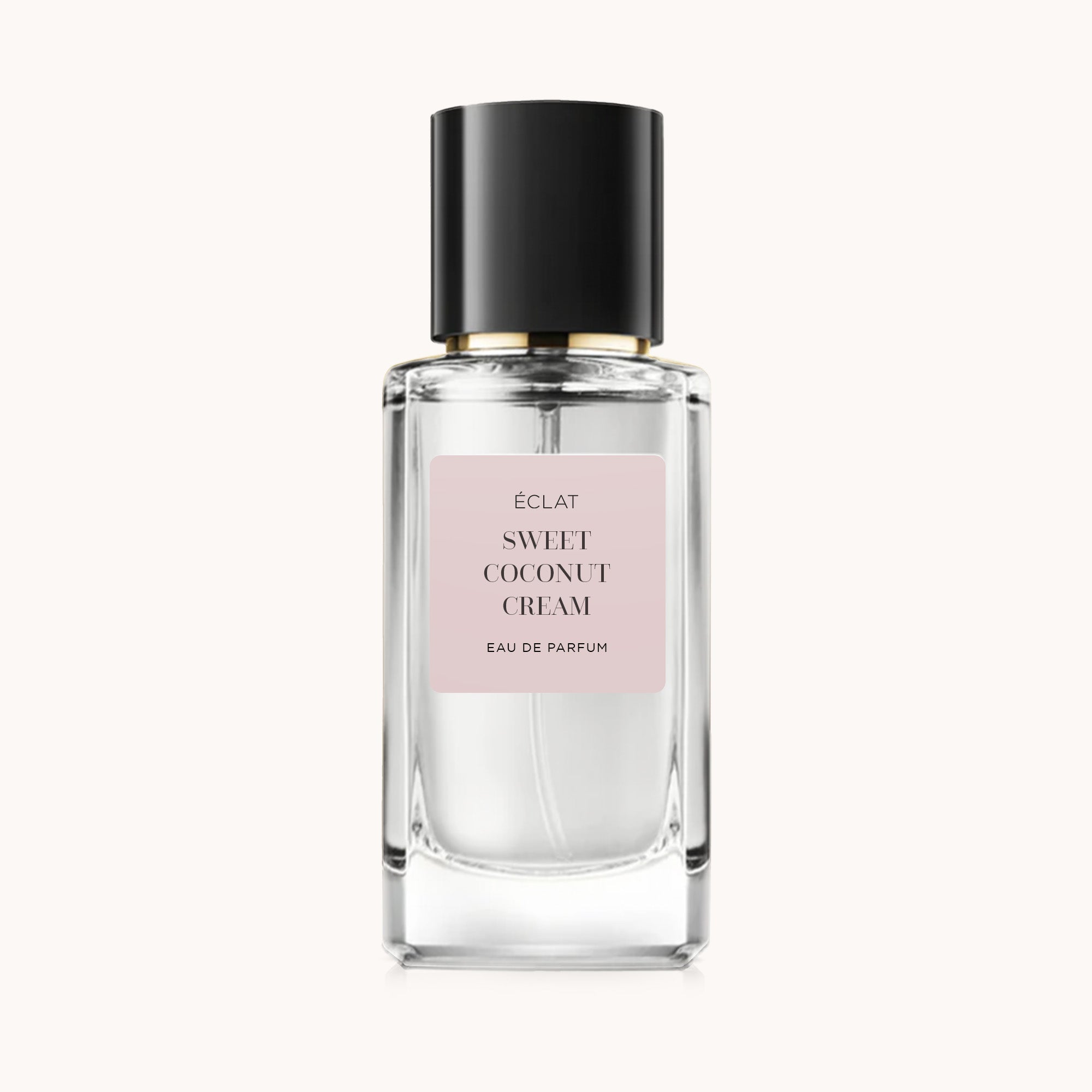 Facettierter Glasflakon mit schwarzem Verschluss und mattem rosa Etikett, zeigt ÉCLAT Sweet Coconut Cream.