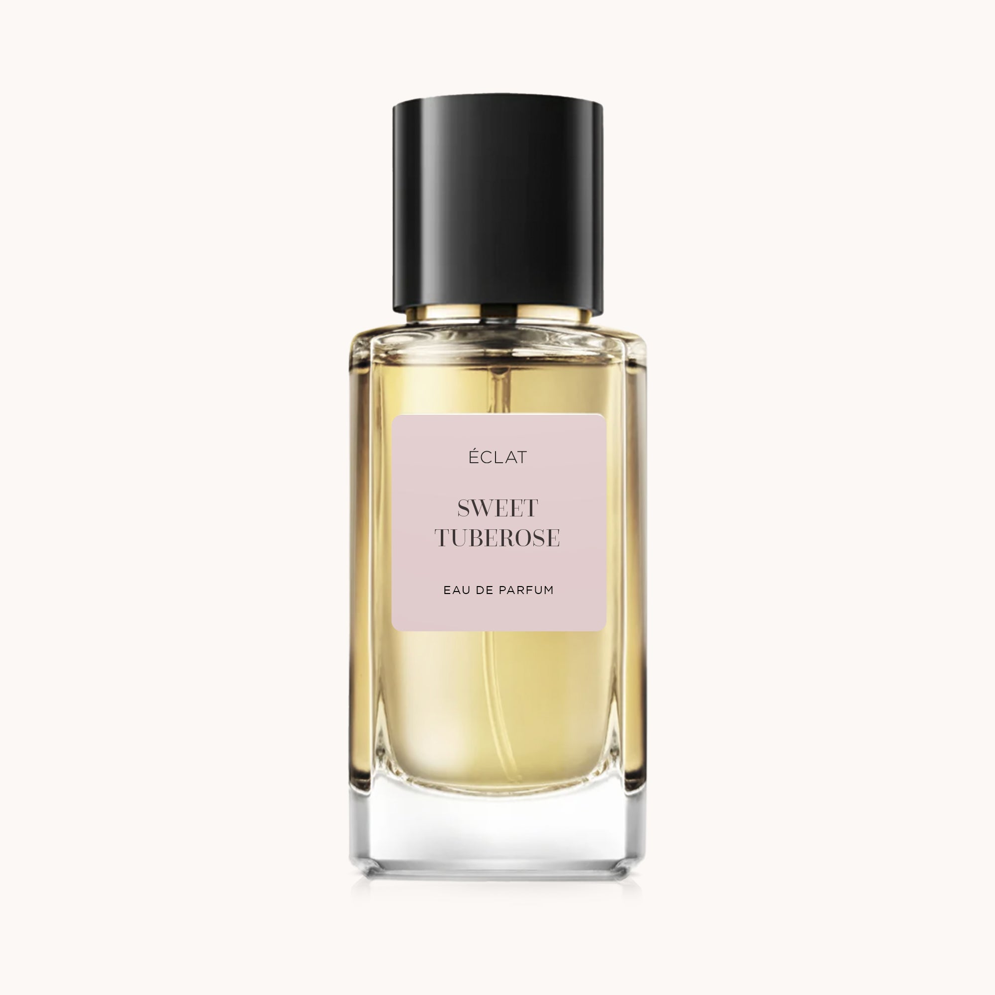 Das ÉCLAT Sweet Tuberose Parfum in einem facettierten Glasflakon mit schwarzer Kappe und rosafarbenem Etikett.